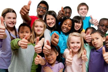group of smiling children giving thumbs up