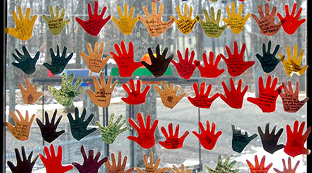brightly colored hand cut outs decorate window