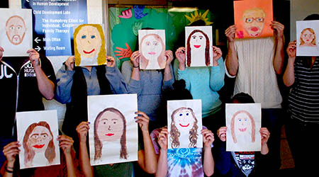 ECS teachers with painted self portraits